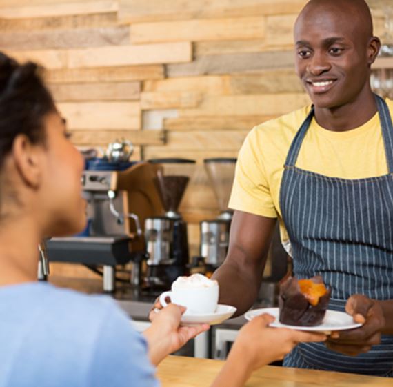 A bunch of dried red chilies strung up in front of a store
